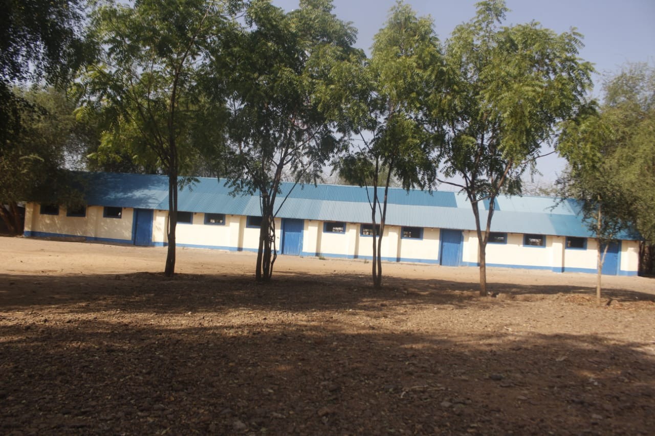 Classroom block and shaded school compound at St. Paul’s Kakuma Secondary School.