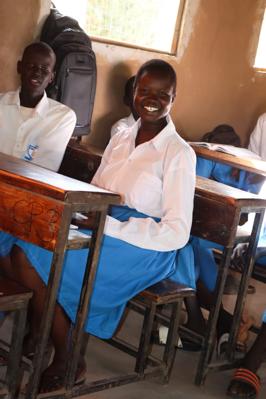A learner smiling during classroom learning.